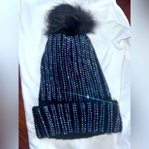 Black  pom-pom  winter hat, covered with rhinestones.